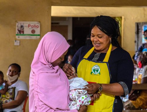 Rotarian and Lagos State immunization officer Bola Orefejo (right) vaccinates a child against polio at Ikosi Health Center in Lagos, Nigeria. 28 July 2020. Find the story in "Rotary" magazine, October 2020.